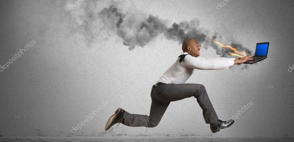 a man running with smoke and flames coming out of his laptop