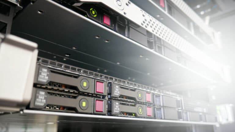 a row of rack-mounted servers, presumably located in a server room, although the background is blurred a little to present more of a neutral image